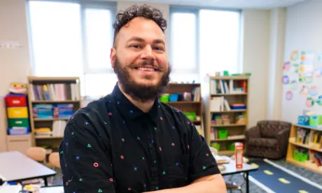 An educator standing in a classroom.