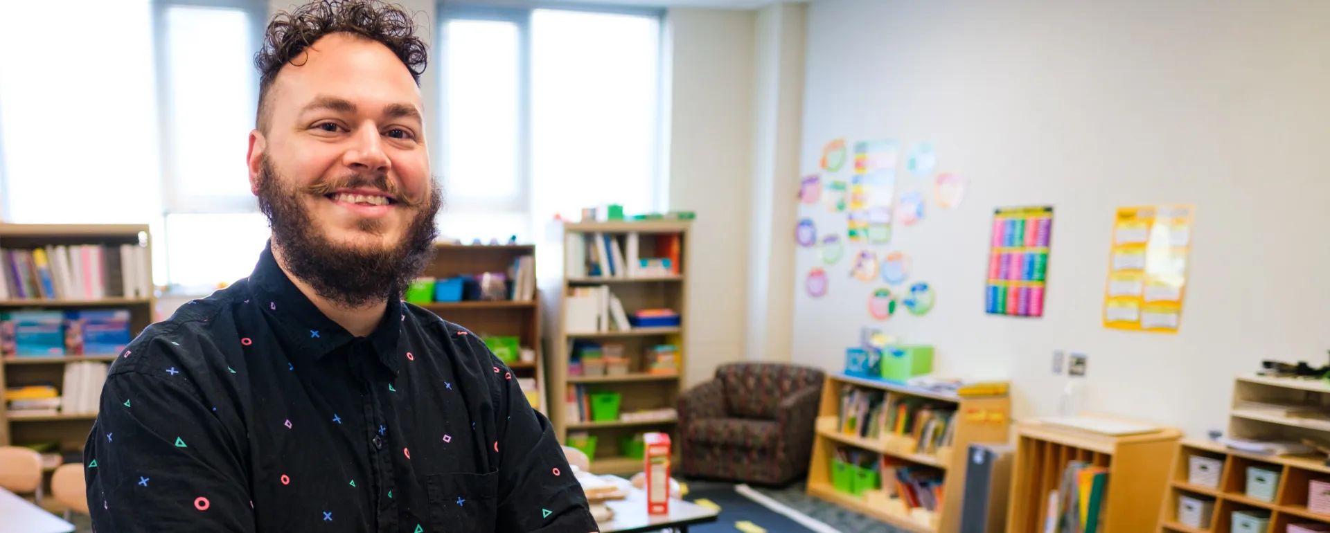 A special education teacher smiling in a classroom.