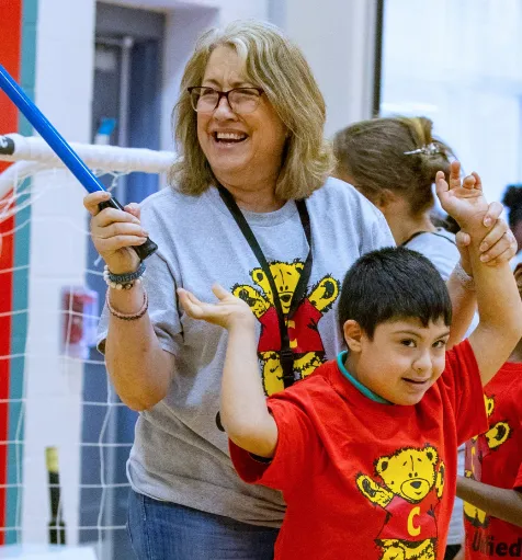 A Special Education Instructional Assistant helping a student with motor skills.