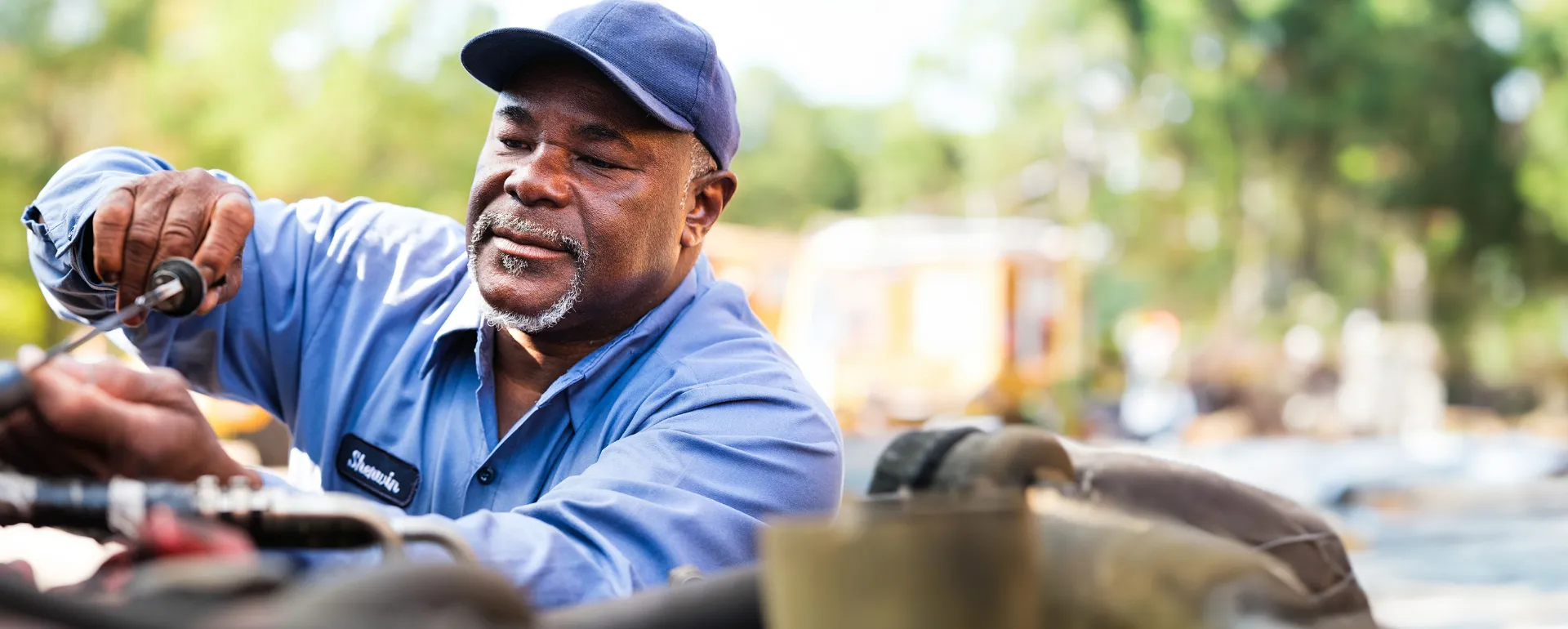 A bus mechanic working on a Wake County Public School System bus.