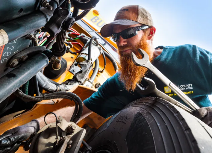 Bus mechanic concentrates on a task at Wake County Public School System.