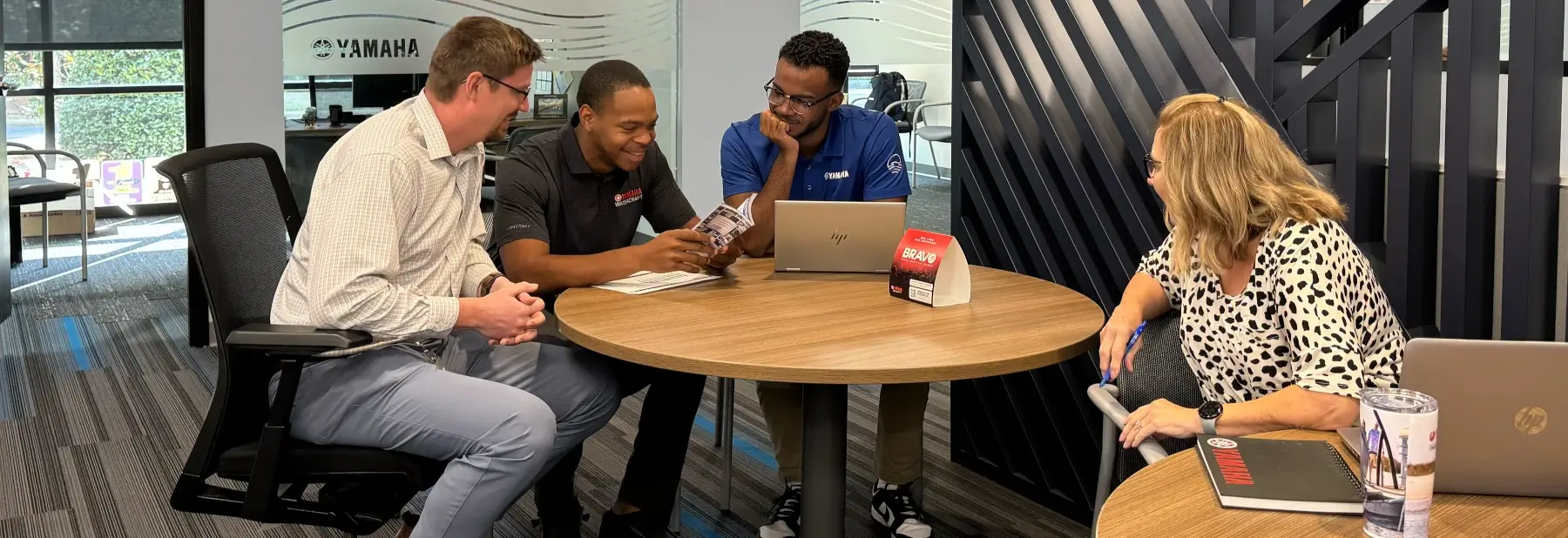 Smiling Yamaha employees working in a sales center.