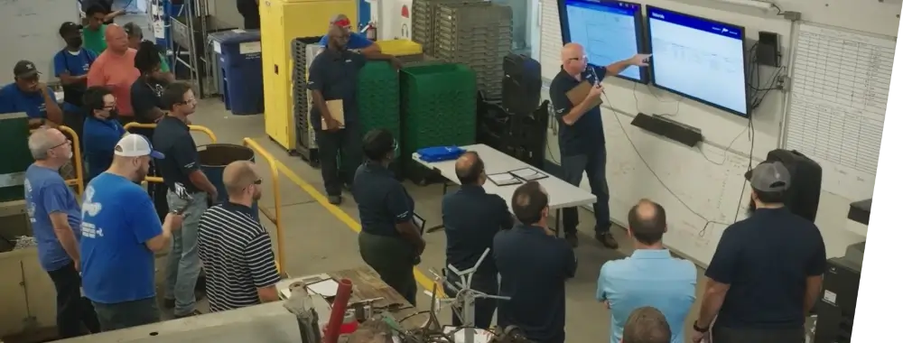 A warehouse supervisor going over the day’s tasks with his employees.