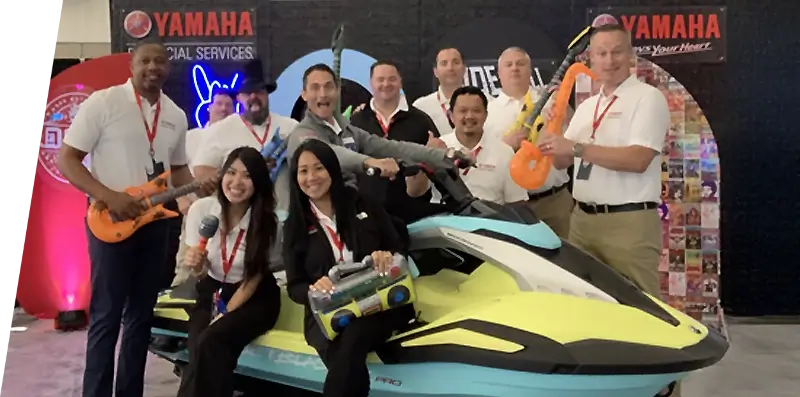 A group of Yamaha Finance employees having fun at a trade show.