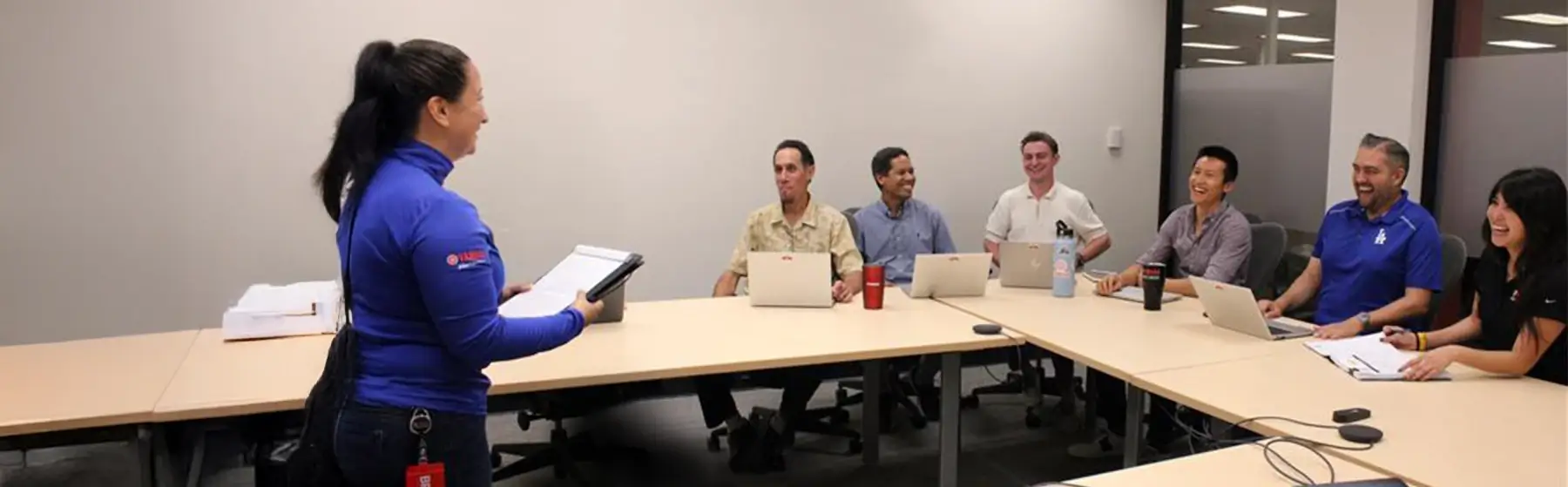 A large group of Yamaha Finance employees laughing together in a conference room.