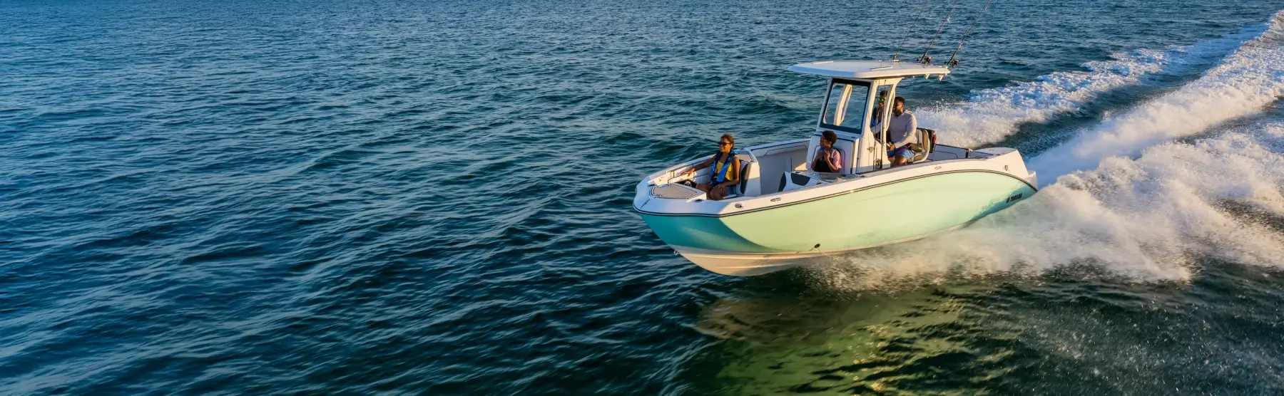 A group of people enjoying a sunny day on the water in a Yamaha boat.