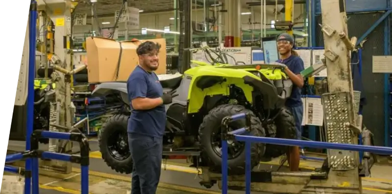 Yamaha employees building an ATV on an assembly line.