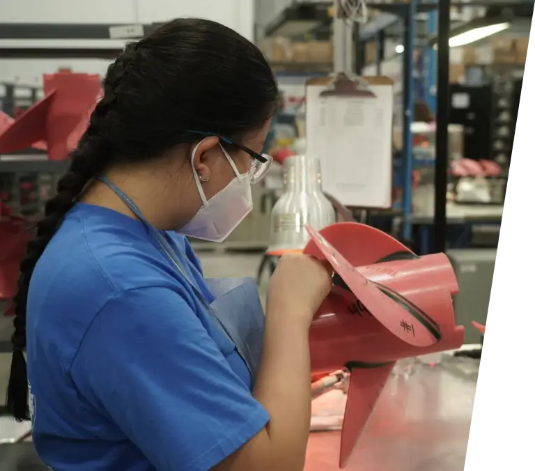 An employee building a propeller mold at a manufacturing facility.