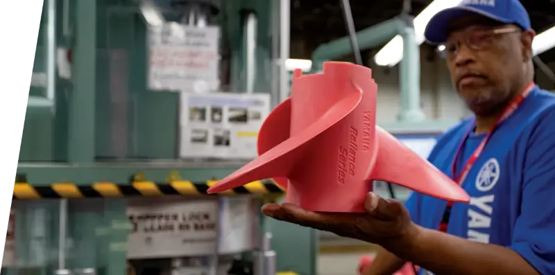 A Yamaha employee holding a Reliance Series propeller mold.