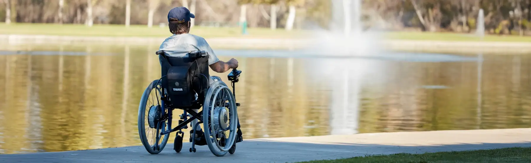 A person using a wheelchair with a Yamaha power assist system.