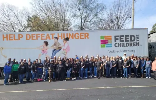 A large group of Yamaha employees at a Feed the Children charity event.