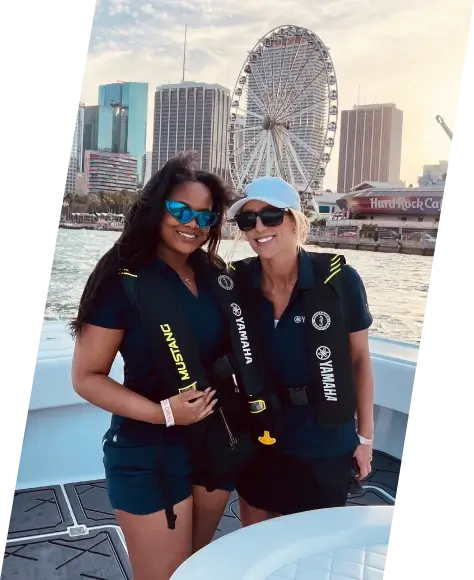 Two people standing in the back of a Yamaha boat in Miami, Florida.