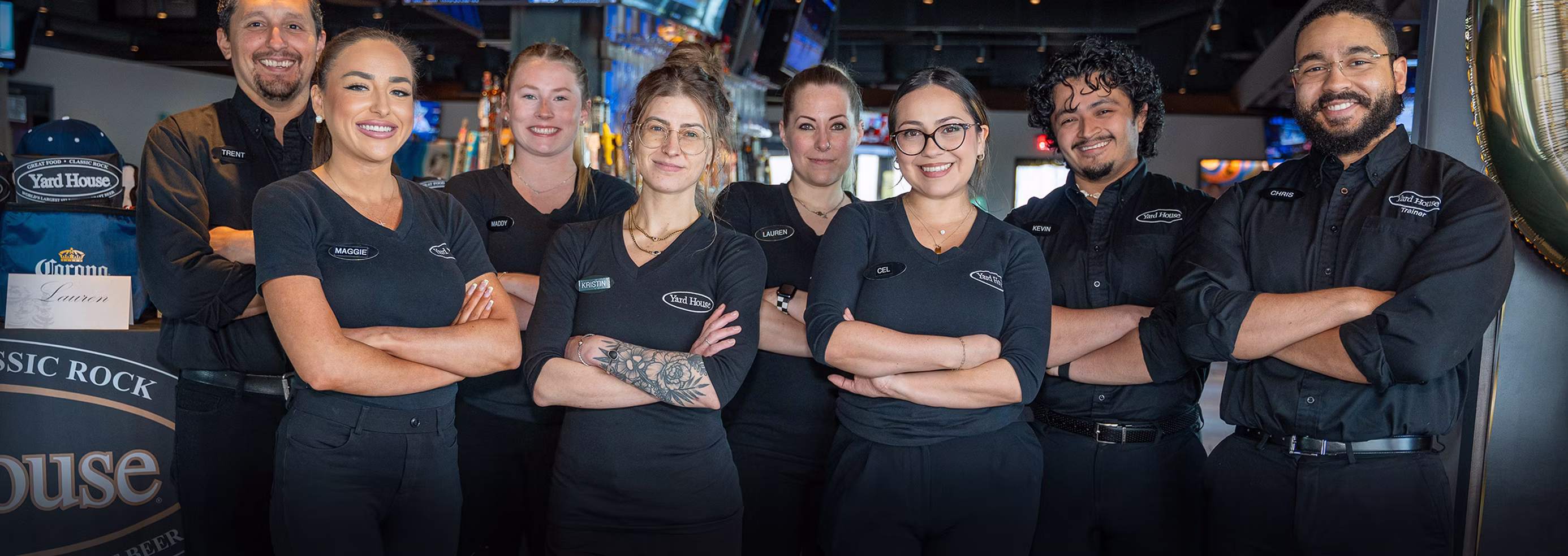 Eight Yard House team members standing together and smiling.