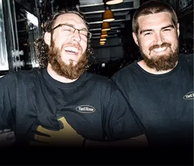 Two smiling bussers/barbacks in the dining area.