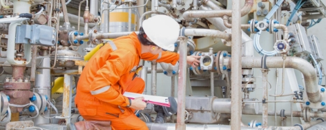 A technician evaluating a system of pipes.