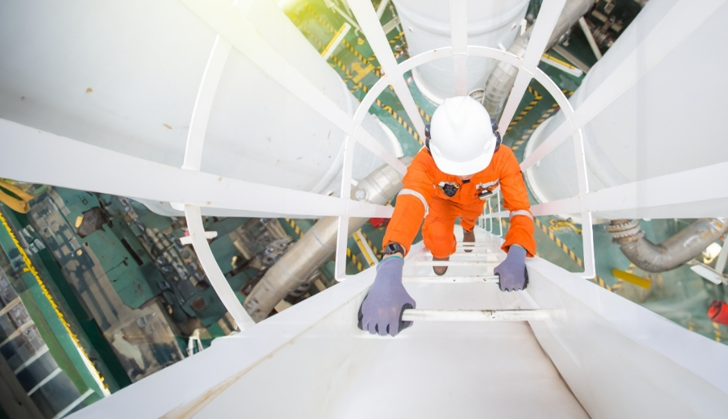 A technician climbing a stack ladder.