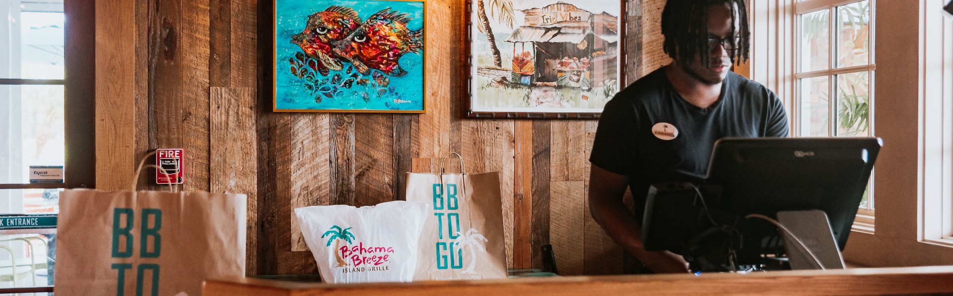 Bahama Breeze employee working at a computer.