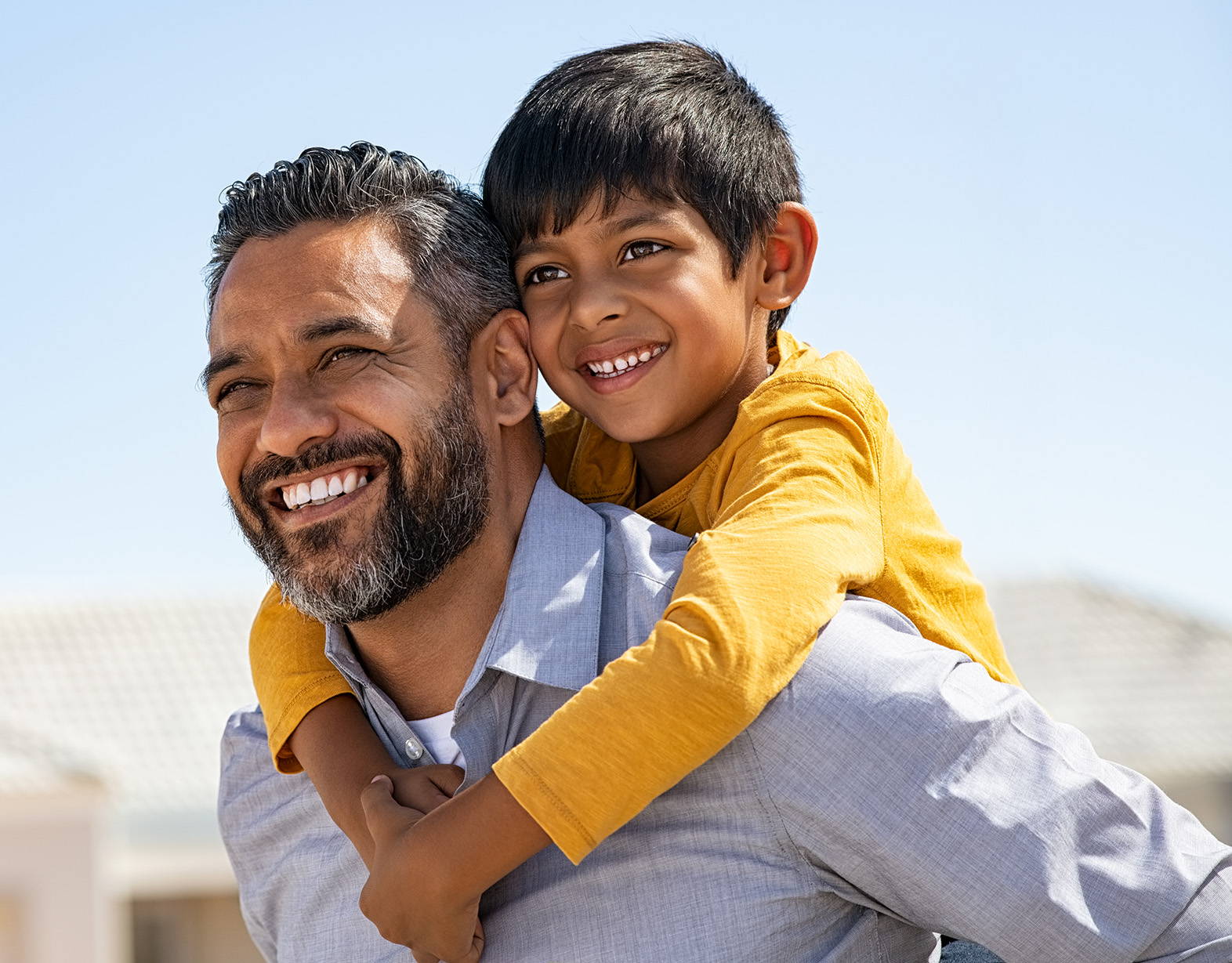 A father and son smiling.