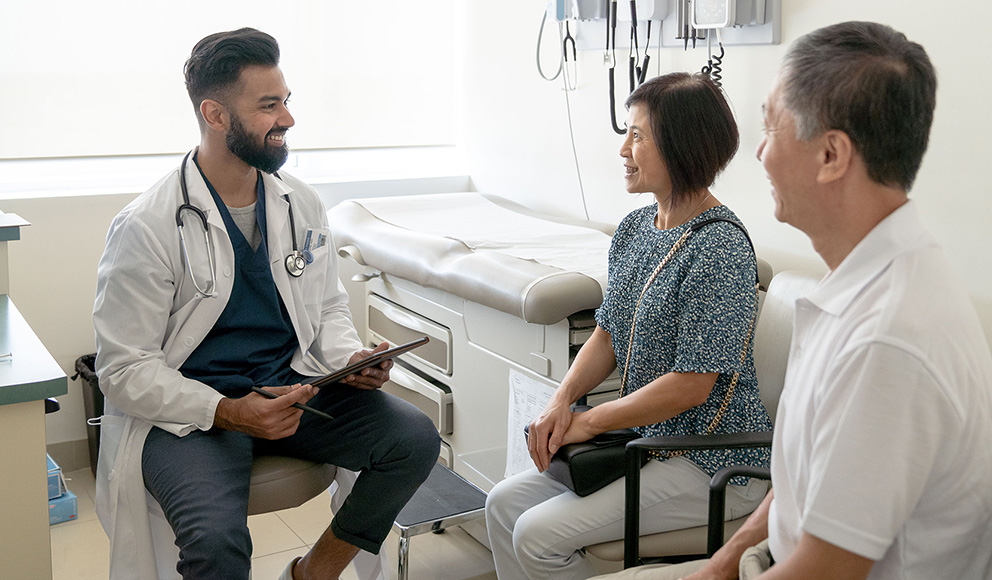 Votion physician meeting with patients in an exam room.