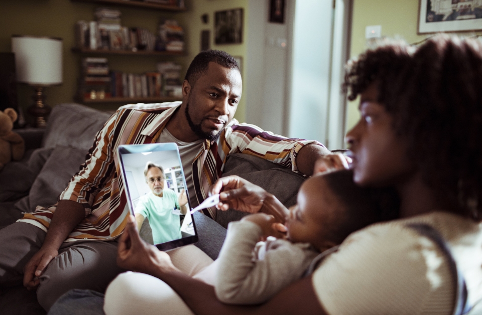 Family at home consulting with Bon Secours Mercy Health physician via tablet