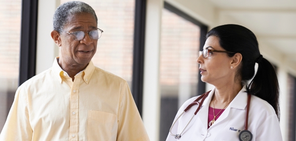 Bon Secours Mercy Health physician and patient walking down a hallway