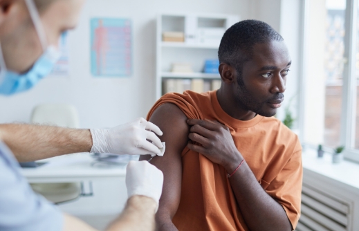  	A medical professional giving a patient an injection.