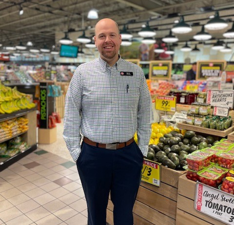 Crestwood store director Ben Ackermann standing and smiling.