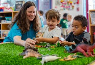 A guide engaging in playtime with students.