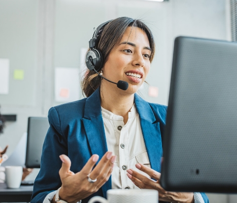 Two corporate professionals smiling and helping their team.