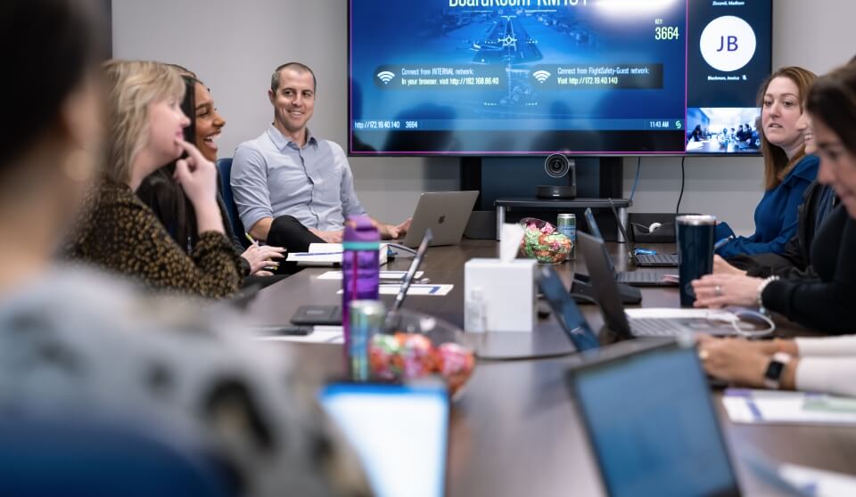 A group of FSI employees having a meeting in a conference room.