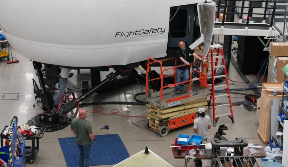 FSI employees working on an FSI simulator.