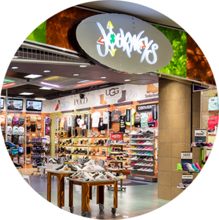The engaging front of Journeys, one of the Genesco brands, in a brightly lit mall.