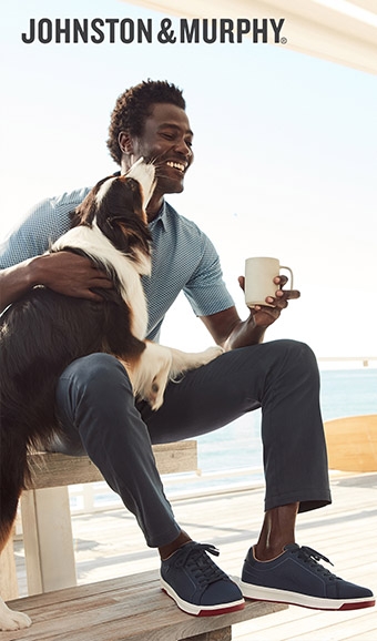 Man with a dog posing in Johnston & Murphy shoes/apparel