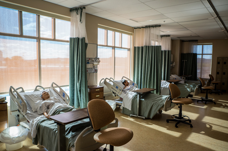 Hospital beds and mannequins in a simulated hospital room at Ivy Tech for training nursing students.