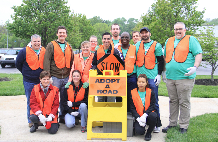 Ivy Tech faculty and students wearing orange vests participate in a community service project.