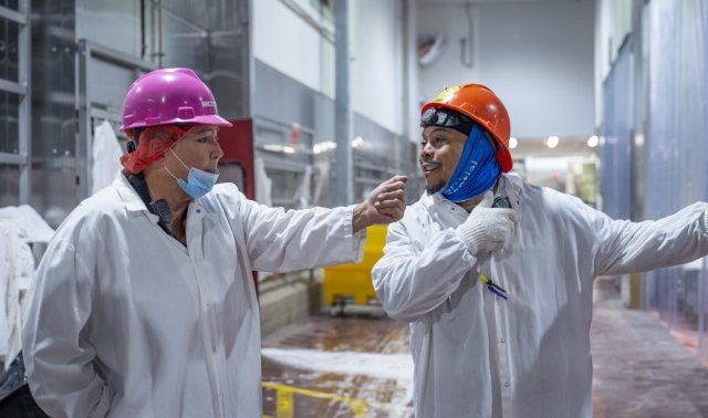  	Two Koch Foods employees smiling while working together