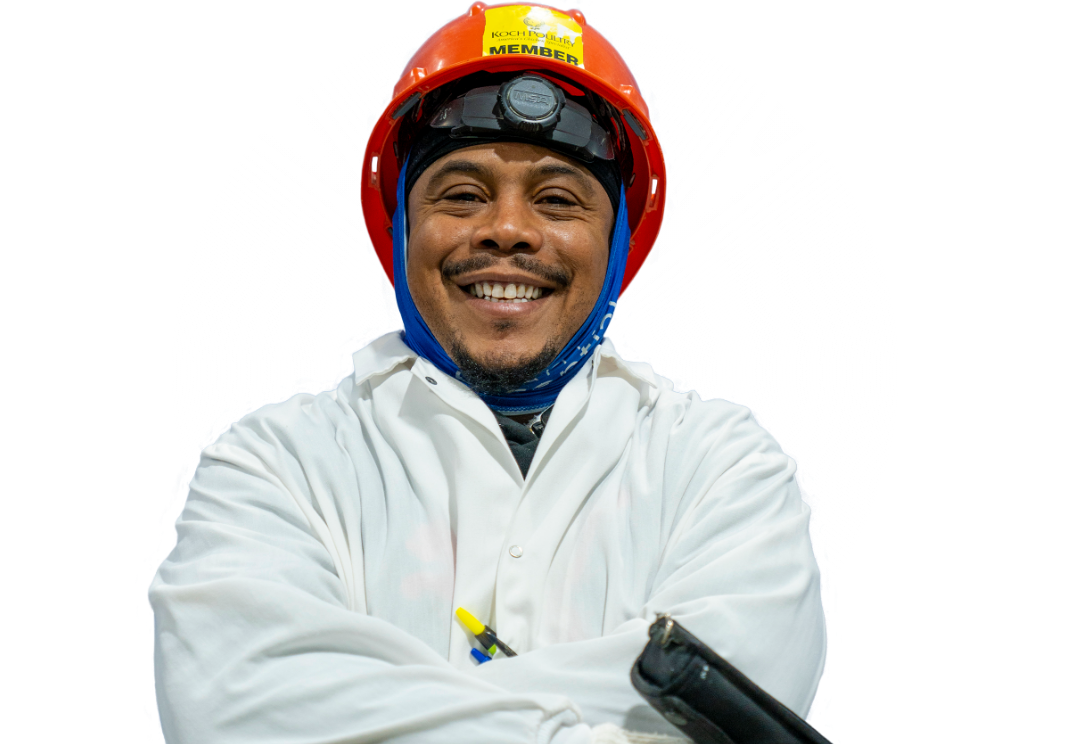  	A Koch Foods employee in a hard hat smiling about their job