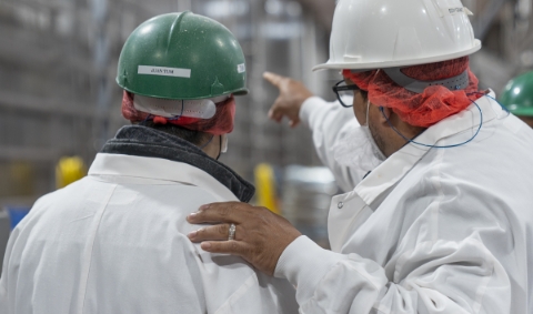 Two Koch Foods employees talking about their work