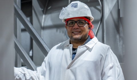  	A Koch Foods employee in a hard hat smiling