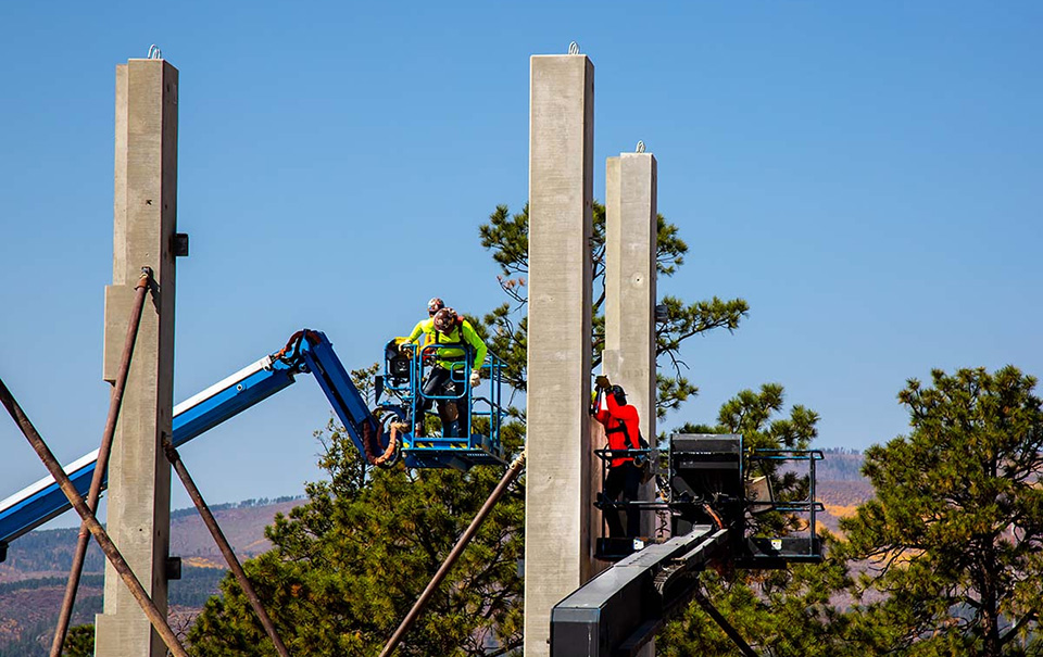 LANL employees in bucket trucks working at a project site.