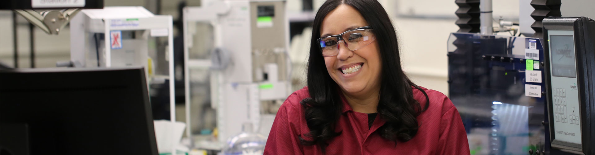 Smiling LANL employee wearing protective glasses