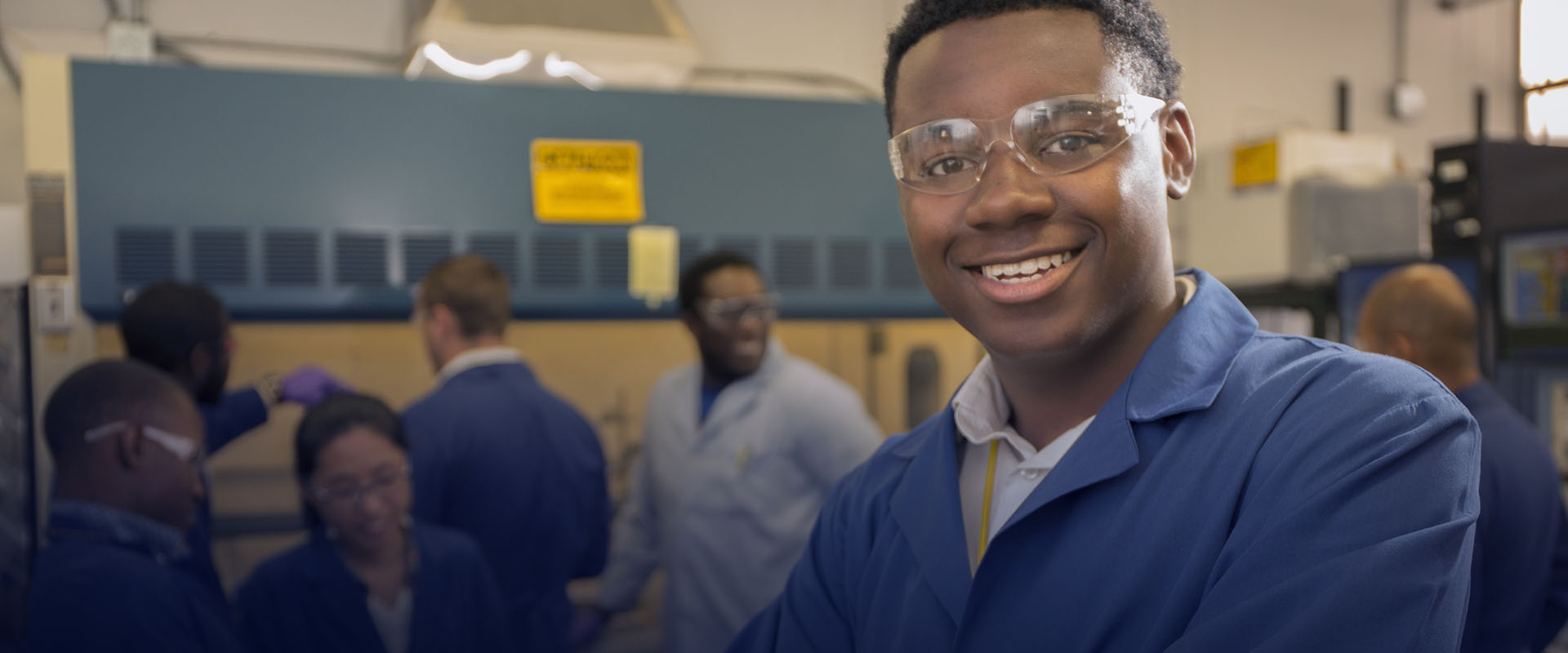 Smiling young student in protective glasses at LANL