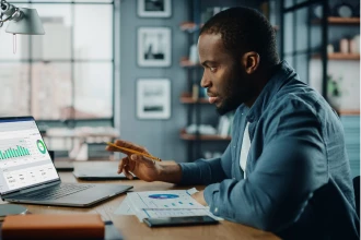 Man checking analytics reports on laptop