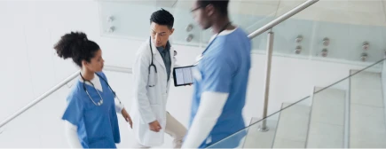 Healthcare professionals going up a staircase in the hospital