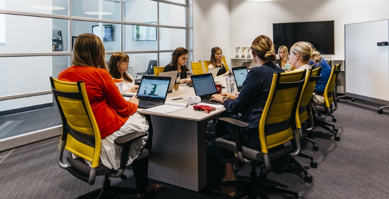  	Employees collaborating on a project in a conference room.