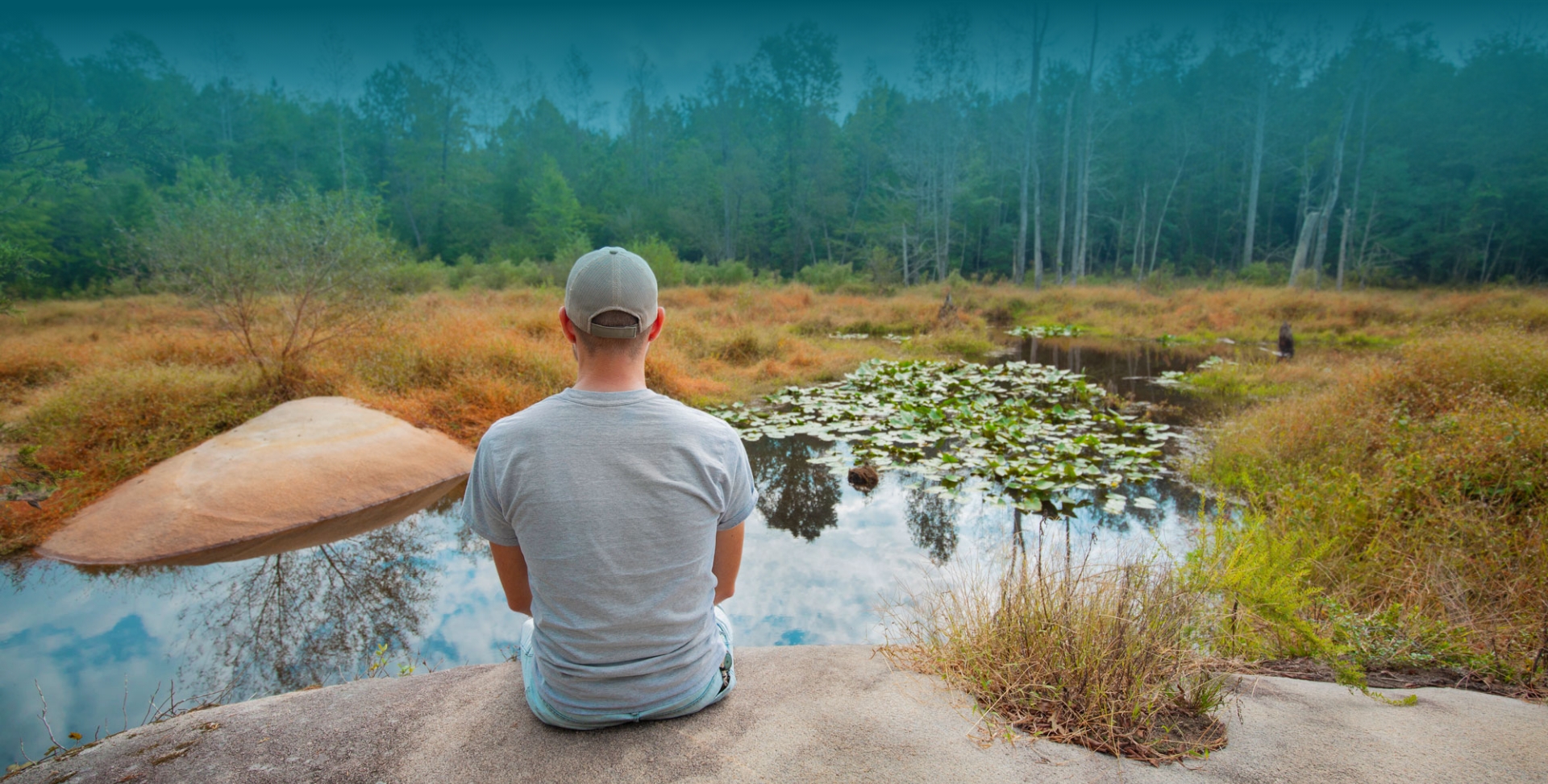  	Man sits on an overlook that showcases beautiful Wake County, North Carolina