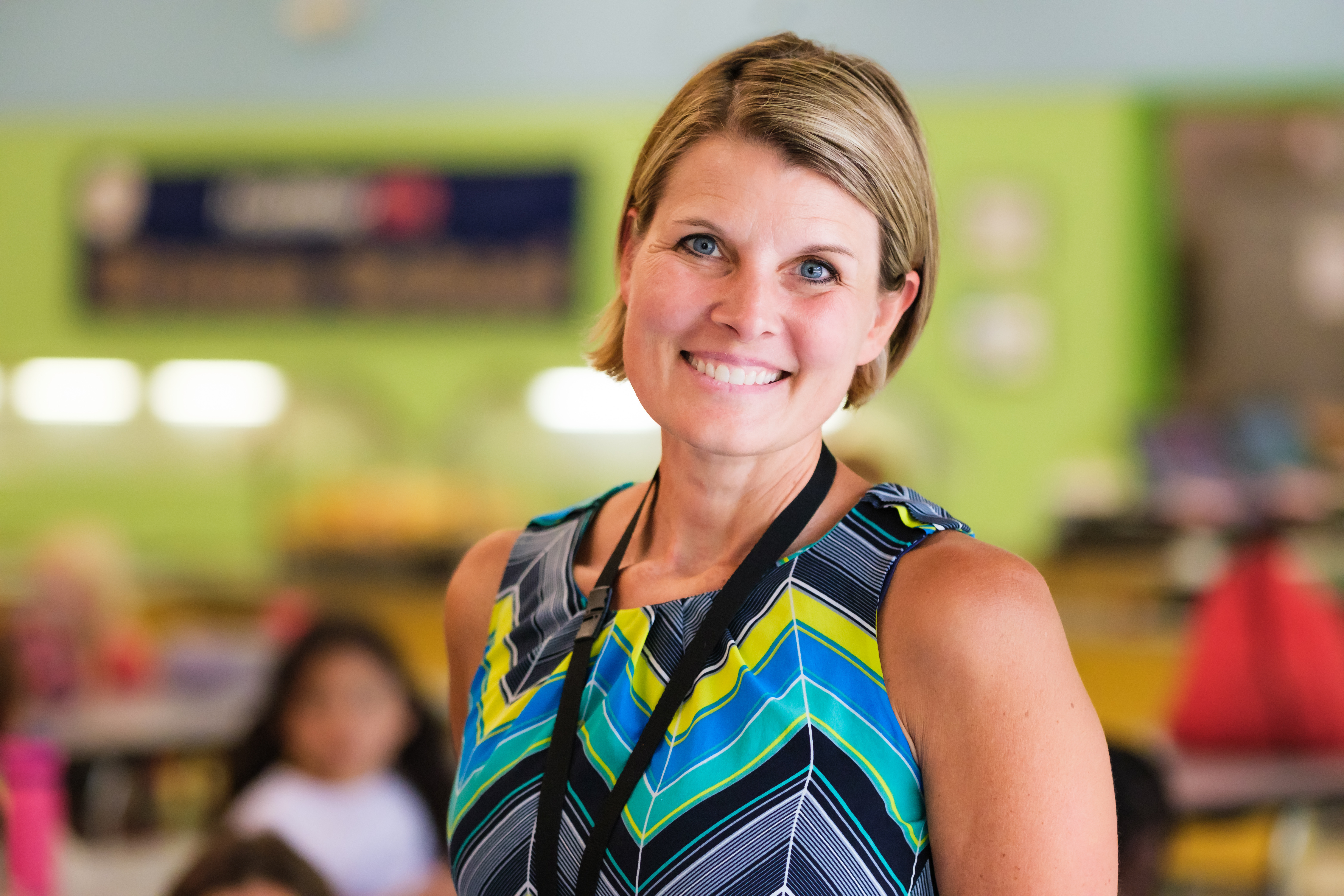 Smiling instructional assistant in the classroom at Wake County Public School System