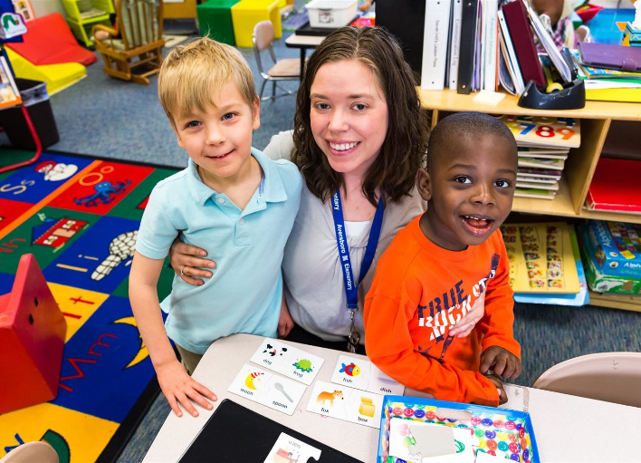 Special Education Instructional Assistant with two young students at Wake County Public School System