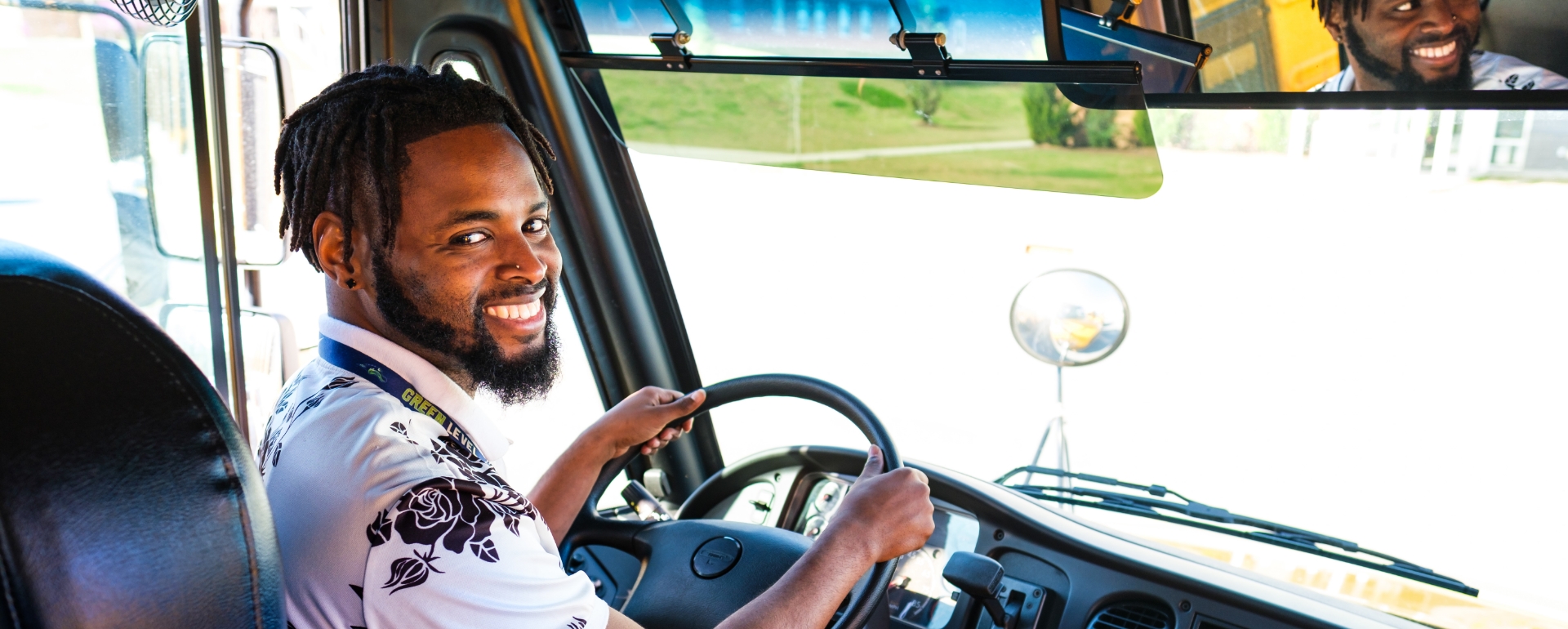  	Smiling bus driver behind the wheel at Wake County Public School System