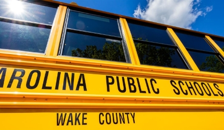 The side of a yellow Wake County school bus